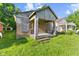 This property needs work, including overgrown grass and boarded-up windows at 3335 W 9Th St, Indianapolis, IN 46222