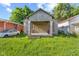This property needs work, including overgrown grass and boarded-up windows at 3335 W 9Th St, Indianapolis, IN 46222