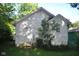 Rear view of the home showing the back door and window, framed by foliage at 3443 N Chester Ave, Indianapolis, IN 46218