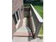 Stairwell view leading down to the basement with brick and concrete construction at 3975 Keyway Dr, Greenwood, IN 46143