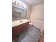 Bathroom with wood vanity, marble countertop, toilet, and blue-toned floors at 3975 Keyway Dr, Greenwood, IN 46143