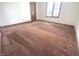 Bedroom with neutral carpet and trim featuring a window and standard closet at 3975 Keyway Dr, Greenwood, IN 46143