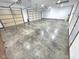 Spacious three car garage with white walls and concrete flooring at 3975 Keyway Dr, Greenwood, IN 46143