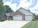 Spacious three-car garage with a large driveway and attractive brick exterior at 3975 Keyway Dr, Greenwood, IN 46143