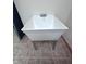 Clean, square utility sink featuring stainless steel legs and neutral floor tile, perfect for laundry or workshop at 3975 Keyway Dr, Greenwood, IN 46143