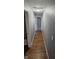 Hallway with wood-look floors offering seamless transition to bedrooms at 4614 Runyon Lake W Dr, Greenwood, IN 46143