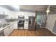 Modern kitchen featuring white cabinets, stainless steel appliances, and granite countertops at 4614 Runyon Lake W Dr, Greenwood, IN 46143