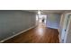 Open-concept living room with hardwood floors and access to kitchen and dining areas at 4614 Runyon Lake W Dr, Greenwood, IN 46143