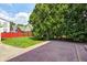 Backyard with patio, lawn, greenery and partially obscured view of houses at 5430 N Kenwood Ave, Indianapolis, IN 46208