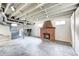 Unfinished basement featuring brick fireplace, window, and mechanicals at 5430 N Kenwood Ave, Indianapolis, IN 46208