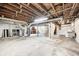 Unfinished basement featuring brick fireplace, mechanicals, and laundry tub at 5430 N Kenwood Ave, Indianapolis, IN 46208
