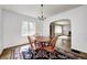 Warm dining room featuring hardwood floors, lots of natural light, and an arched doorway at 5430 N Kenwood Ave, Indianapolis, IN 46208