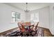 Cozy dining room featuring hardwood floors, lots of natural light, and classic chandelier at 5430 N Kenwood Ave, Indianapolis, IN 46208