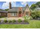 Charming brick home featuring landscaped front yard and covered porch at 5430 N Kenwood Ave, Indianapolis, IN 46208