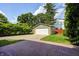 View of detached garage and driveway from the brick paved backyard patio at 5430 N Kenwood Ave, Indianapolis, IN 46208