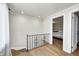 Hallway has wood floors, bead board ceiling, and a view into a bedroom at 5430 N Kenwood Ave, Indianapolis, IN 46208
