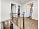 A naturally lit hallway with hardwood floors and openings into the bath and bedroom at 5430 N Kenwood Ave, Indianapolis, IN 46208