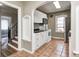 A bright kitchen features white cabinets, stainless appliances, and charming archway, perfect for cooking at 5430 N Kenwood Ave, Indianapolis, IN 46208