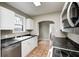 An eat-in kitchen is equipped with a sink, white cabinetry, and stainless steel dishwasher at 5430 N Kenwood Ave, Indianapolis, IN 46208