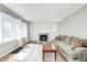 Well-lit living room featuring hardwood floors, a cozy fireplace, neutral walls and lots of natural light at 5430 N Kenwood Ave, Indianapolis, IN 46208
