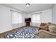 A cozy living room with neutral colors, wood floors, area rug, and bright natural light at 5430 N Kenwood Ave, Indianapolis, IN 46208