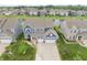Aerial view of a light blue, two-story home in a well-kept suburban neighborhood with a pond at 5473 Forest Glen Dr, Brownsburg, IN 46112