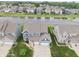 Beautiful aerial view showcases the home's manicured front lawn, spacious driveway, and pond views at 5473 Forest Glen Dr, Brownsburg, IN 46112