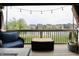 Relaxing back deck with string lights and tranquil water views in a suburban neighborhood at 5473 Forest Glen Dr, Brownsburg, IN 46112