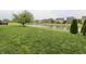 Expansive backyard featuring a serene pond view and well-manicured green lawn at 5473 Forest Glen Dr, Brownsburg, IN 46112