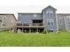 Spacious backyard featuring a deck, lush lawn, and mature landscaping at 5473 Forest Glen Dr, Brownsburg, IN 46112