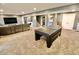 Large finished basement featuring a modern entertainment area and a ping pong table for recreational activities at 5473 Forest Glen Dr, Brownsburg, IN 46112