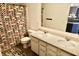 Well-lit bathroom with a double vanity, accented by a colorful shower curtain and coordinated rug at 5473 Forest Glen Dr, Brownsburg, IN 46112