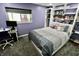 Cozy bedroom featuring built-in bookshelves, study area, and soft, natural lighting at 5473 Forest Glen Dr, Brownsburg, IN 46112