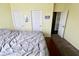 Comfortable bedroom with a gray comforter, a wooden chest, and two closet doors at 5473 Forest Glen Dr, Brownsburg, IN 46112
