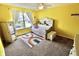 Bright bedroom with yellow walls, a daybed, and a rainbow-themed rug at 5473 Forest Glen Dr, Brownsburg, IN 46112