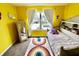 Bright, yellow bedroom has a rainbow rug with a daybed, and mirror at 5473 Forest Glen Dr, Brownsburg, IN 46112