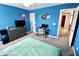 Vibrant blue bedroom with a ceiling fan, gray dresser, a desk, and a comfy green bed at 5473 Forest Glen Dr, Brownsburg, IN 46112