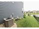 Exterior home featuring lush landscaping, well-maintained lawn, and a modern air conditioning unit at 5473 Forest Glen Dr, Brownsburg, IN 46112