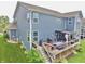 Backyard with a deck, patio, lush landscaping, and vibrant green lawn, perfect for outdoor living at 5473 Forest Glen Dr, Brownsburg, IN 46112