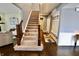 Inviting foyer with staircase, dark wood floors, and neutral paint at 5473 Forest Glen Dr, Brownsburg, IN 46112