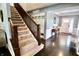 Foyer boasts hardwood floors, a carpeted staircase, and a 'Simply Blessed' sign above built-in storage at 5473 Forest Glen Dr, Brownsburg, IN 46112