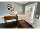 Elegant foyer featuring a stylish console table and dark hardwood floors at 5473 Forest Glen Dr, Brownsburg, IN 46112