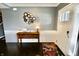 Foyer features a stylish console table, a round mirror wall decor, and dark hardwood flooring at 5473 Forest Glen Dr, Brownsburg, IN 46112