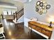 Spacious foyer featuring a staircase and dark hardwood flooring that leads into the living area at 5473 Forest Glen Dr, Brownsburg, IN 46112