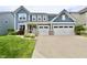 Charming two-story home with a two car garage, landscaped yard, and light blue siding at 5473 Forest Glen Dr, Brownsburg, IN 46112