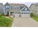 Stylish two-story home with light blue siding, a two-car garage and a well-manicured lawn at 5473 Forest Glen Dr, Brownsburg, IN 46112