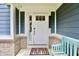 Inviting covered front porch with a vibrant colored bench and a 'hello' welcome mat at 5473 Forest Glen Dr, Brownsburg, IN 46112