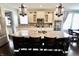 Kitchen island with seating, granite countertops and stainless steel appliances at 5473 Forest Glen Dr, Brownsburg, IN 46112