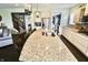 Open-concept kitchen island with granite countertop, stainless steel appliances, and modern lighting at 5473 Forest Glen Dr, Brownsburg, IN 46112