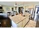 Kitchen island features granite countertop, stainless steel sink, and barstool seating at 5473 Forest Glen Dr, Brownsburg, IN 46112
